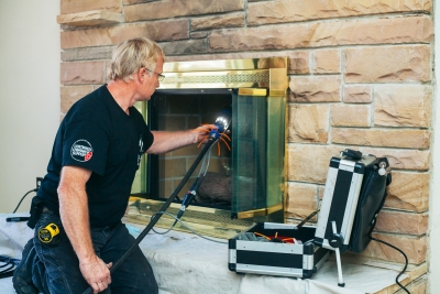 Sweeping a chimney with a digital camera in an Alabama fireplace.